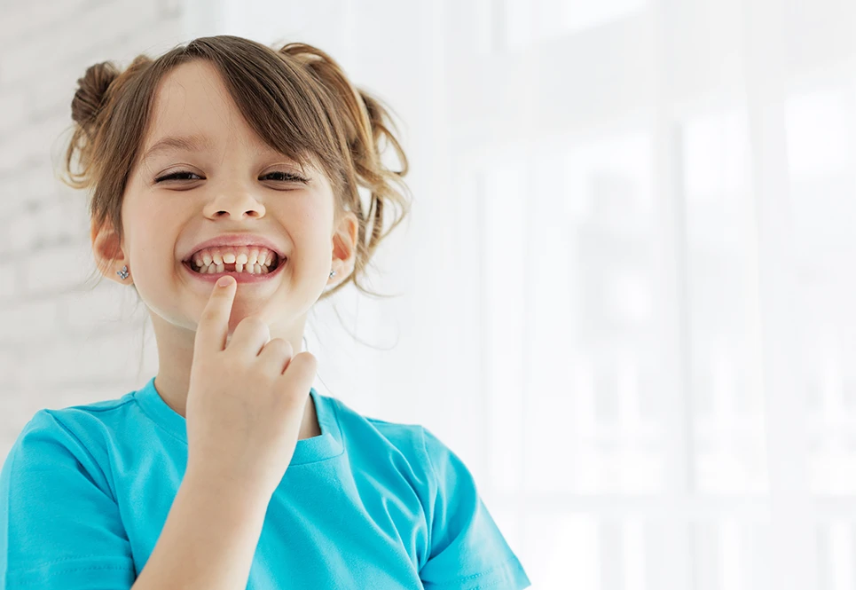 Young girl toddler with a missing tooth.