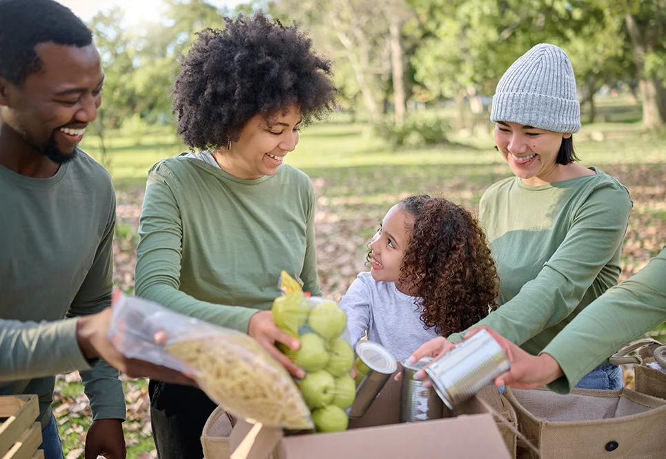 Young family volunteering at a canned food drive.