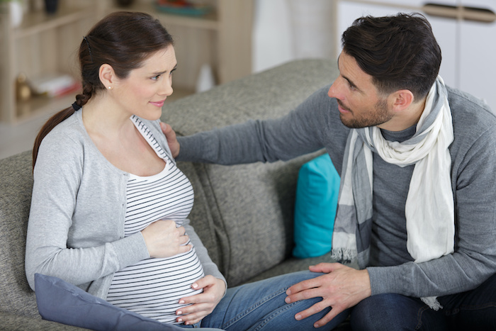 A husband being supportive of his pregnant wife, experiencing perinatal anxiety. 