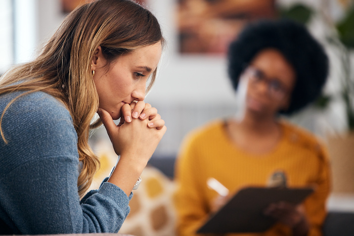 New mom talking with a licensed clinical social worker about her perinatal anxiety.