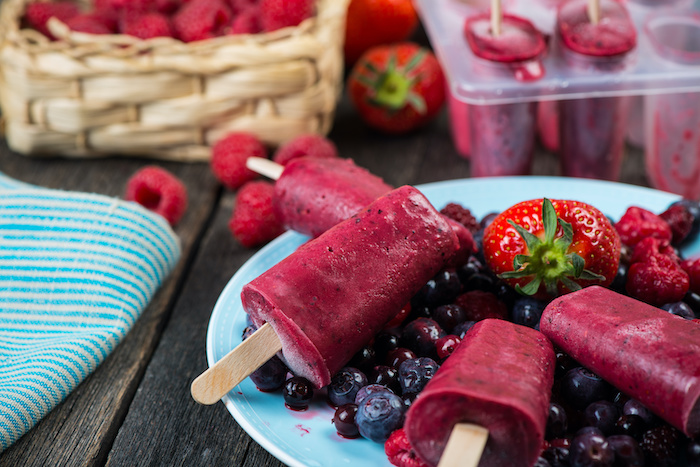 Purple berry popsicles made from raspberries, strawberries and blueberries.