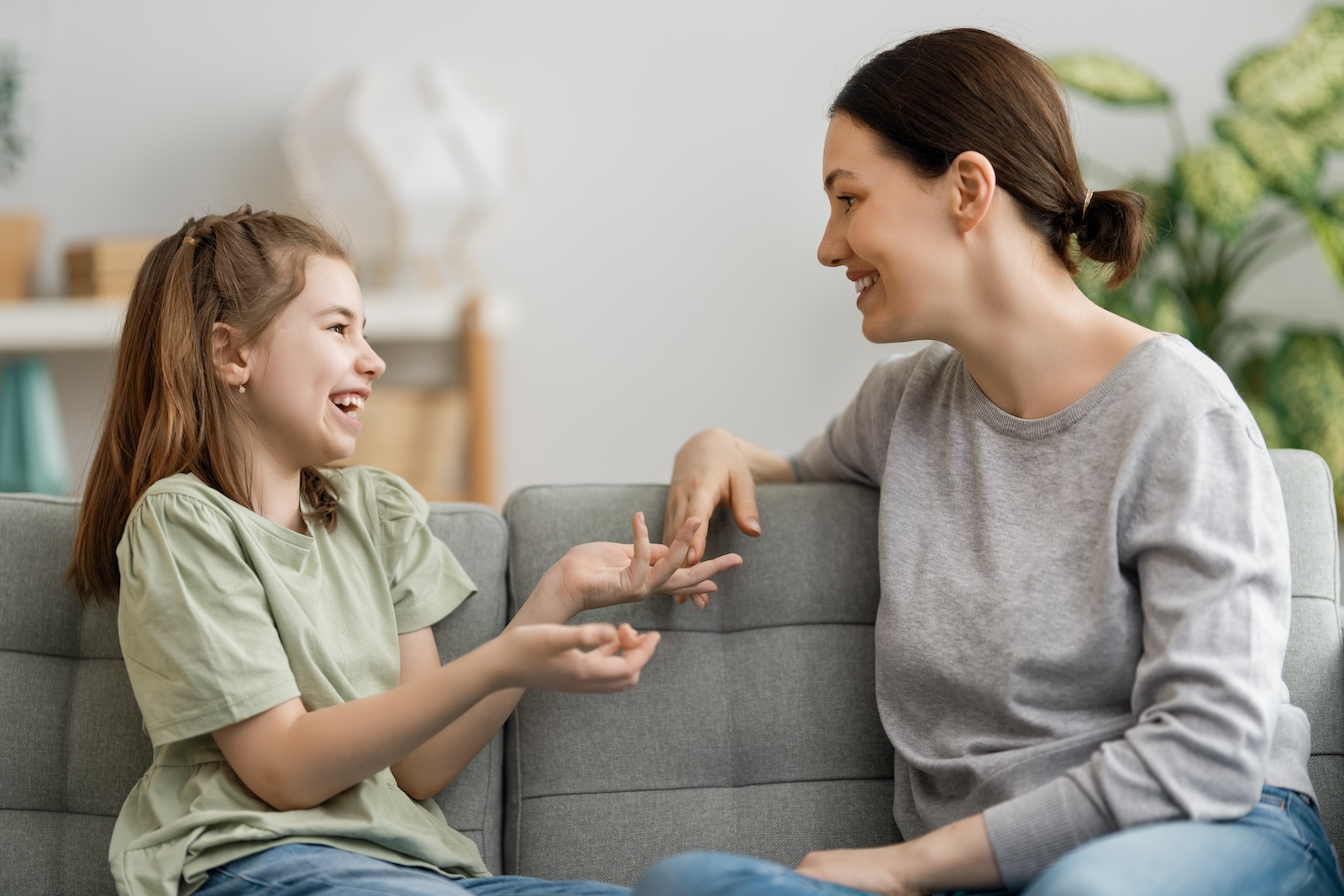 Youthful mother speaking warmly to her daughter.