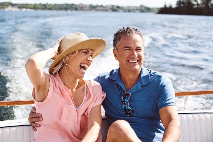 Smiling mother enjoying a cruise with her husband. 