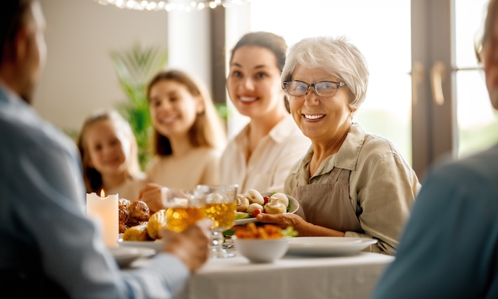Closeup of a mother having Mother’s Day dinner with her family.