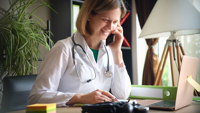 Pediatric medical assistant emailing a patient.