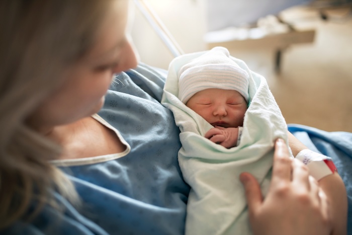 Image of healthy newborn in her mother’s arms.