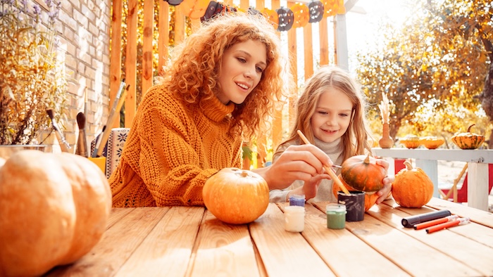 Family carving pumpkins at home. 
