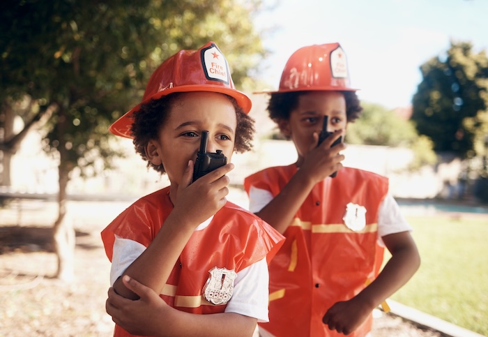Two children dressed as firefighters.