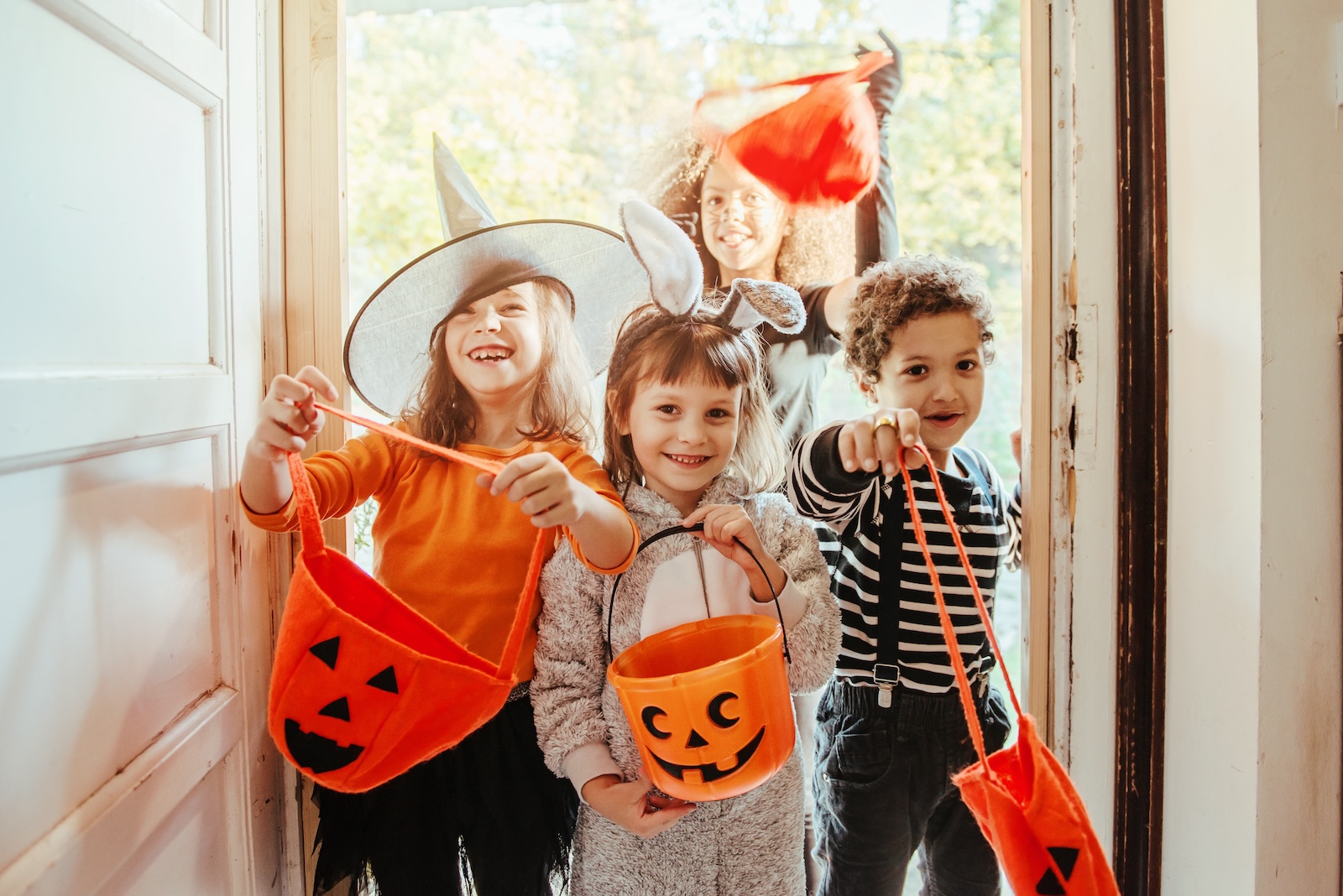 A group of kids trick-or-treating on Halloween