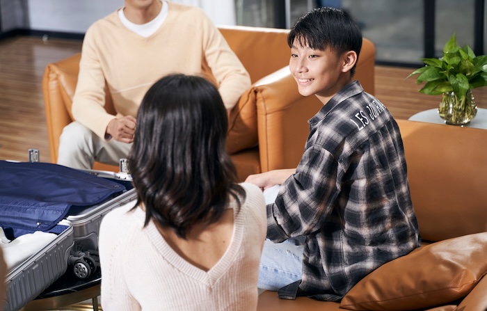 Pair of parents having a discussion in a living room.