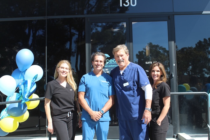 Head staff at Ocean Pediatrics standing outside a building in Orange County.
