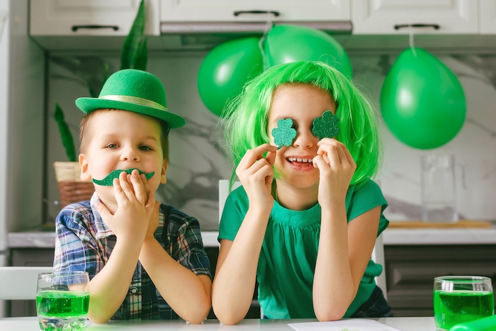 Two young kids dressed in green, celebrating St. Patrick’s Day