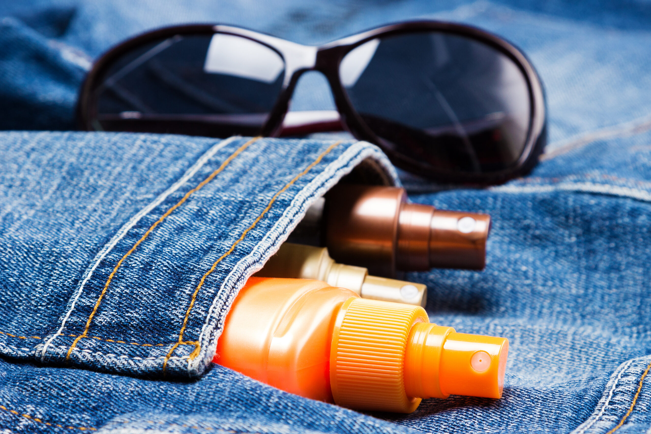 Closeup of sunscreen in a woman’s denim jacket.